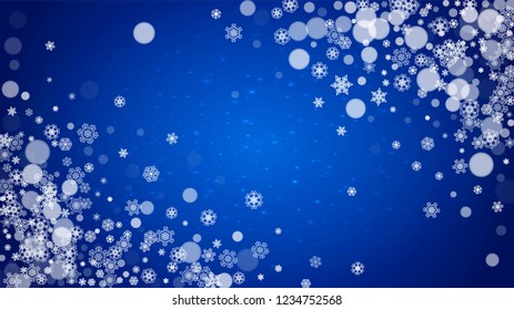 Christmas frame with falling snow on blue background with sparkles. Horizontal Christmas frame with white frosty snowflakes for banners, gift cards, party invitations and special business offers.