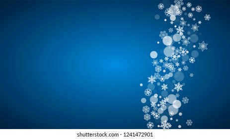 Christmas frame with falling snow on blue background. Horizontal Merry Christmas frame with white frosty snowflakes for banners, gift cards, party invitations and special business offers.