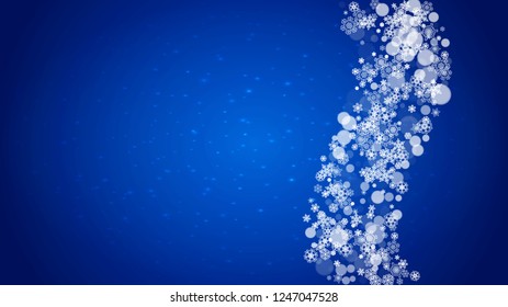 Christmas frame with falling snow on blue background with sparkles. Horizontal Christmas frame with white frosty snowflakes for banners, gift cards, party invitations and special business offers.