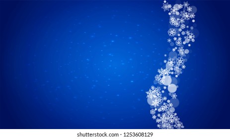 Christmas frame with falling snow on blue background with sparkles. Horizontal Christmas frame with white frosty snowflakes for banners, gift cards, party invitations and special business offers.