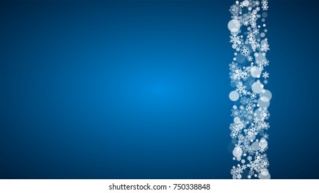 Christmas frame with falling snow on blue background. Horizontal Merry Christmas frame with white frosty snowflakes for banners, gift cards, party invitations and special business offers.