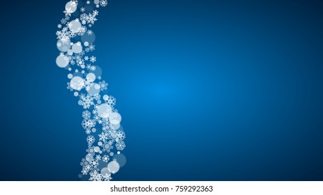 Christmas frame with falling snow on blue background. Horizontal Merry Christmas frame with white frosty snowflakes for banners, gift cards, party invitations and special business offers.
