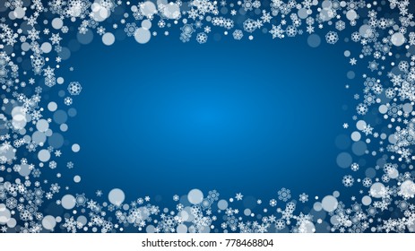 Christmas frame with falling snow on blue background. Horizontal Merry Christmas frame with white frosty snowflakes for banners, gift cards, party invitations and special business offers.