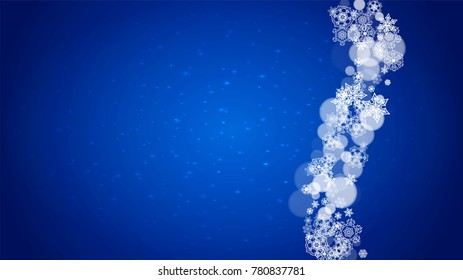 Christmas frame with falling snow on blue background with sparkles. Horizontal Christmas frame with white frosty snowflakes for banners, gift cards, party invitations and special business offers.