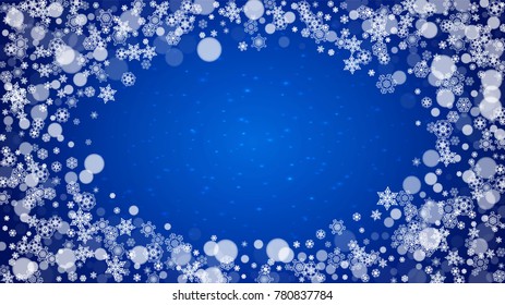 Christmas frame with falling snow on blue background with sparkles. Horizontal Christmas frame with white frosty snowflakes for banners, gift cards, party invitations and special business offers.