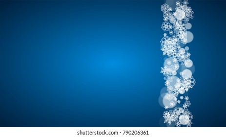 Christmas frame with falling snow on blue background. Horizontal Merry Christmas frame with white frosty snowflakes for banners, gift cards, party invitations and special business offers.