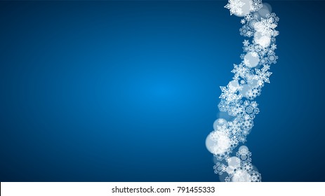 Christmas frame with falling snow on blue background. Horizontal Merry Christmas frame with white frosty snowflakes for banners, gift cards, party invitations and special business offers.