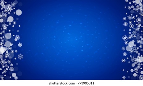 Christmas frame with falling snow on blue background with sparkles. Horizontal Christmas frame with white frosty snowflakes for banners, gift cards, party invitations and special business offers.