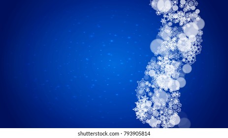 Christmas frame with falling snow on blue background with sparkles. Horizontal Christmas frame with white frosty snowflakes for banners, gift cards, party invitations and special business offers.