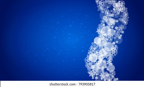 Christmas frame with falling snow on blue background with sparkles. Horizontal Christmas frame with white frosty snowflakes for banners, gift cards, party invitations and special business offers.