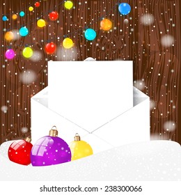 Christmas garland and ball and envelope, with snowflakes on the wooden background.