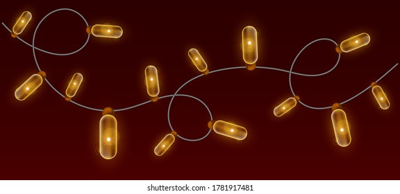Christmas garland on a brown background. Banner with garland of yellow bulbs.