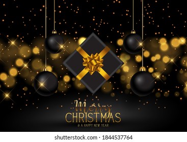 Christmas gift and baubles on a gold bokeh lights background