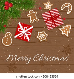 Christmas gift box and fir tree branch on wooden table