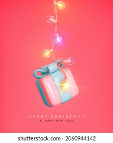 Christmas gift box hanging on bright glowing Xmas garland. Realistic 3d design of New Year present surprise. Festive card, invitations, cover brochures. Holiday banner, web poster. Vector illustration