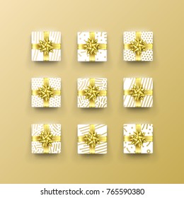 Christmas gift box present in golden ribbon bow and wrapping paper dotted gold foil pattern. Luxury Christmas gift boxes set for Birthday, New Year holiday greeting card vector black background