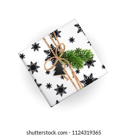 Christmas gift box top view. Realistic illustration. Black and white wrapping paper. Decoration of Christmas toys and Christmas branches. EPS10.