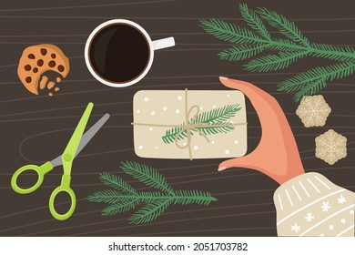 Christmas gift packaging. Preparations for Christmas and New Year Flat vector isolated. Hand with winter sweater holds gift. Spruce twigs, scissors, paper snowflakes, coffee, coocie. Holiday decor.