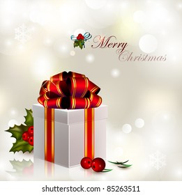 Christmas gift with red bow on sparkling silvery background