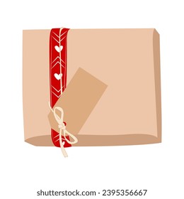 Christmas gifts in kraft paper with red ribbon and card.
