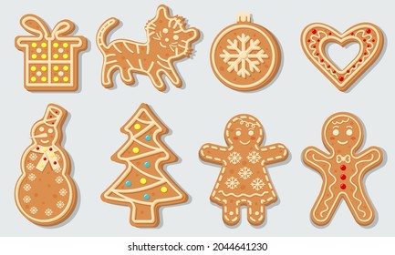 Christmas gingerbread cookies in the shape of Christmas ball, Christmas tree, tiger, heart, snowman, gift and gingerbread men. Sweet homemade glazed biscuits.