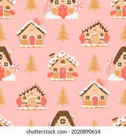 Christmas gingerbread houses and trees in cartoon style on pink background seamless pattern with snowflakes