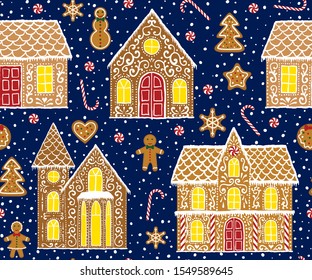 Christmas gingerbread seamless pattern with gingerbread houses on dark blue background