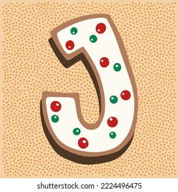 Christmas gingerbread in the shape of a letter J with white icing doodle