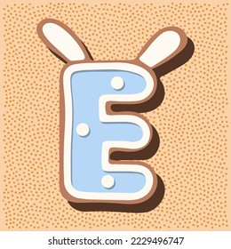 Christmas gingerbread in the shape of the letter with rabbit ears, white blue glaze, polka dots