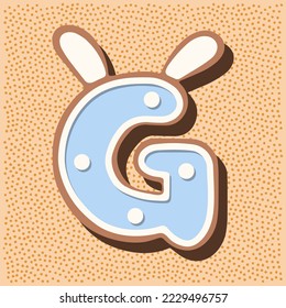 Christmas gingerbread in the shape of the letter with rabbit ears, white blue glaze, polka dots