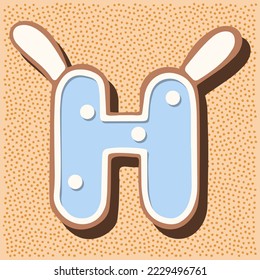Christmas gingerbread in the shape of the letter with rabbit ears, white blue glaze, polka dots