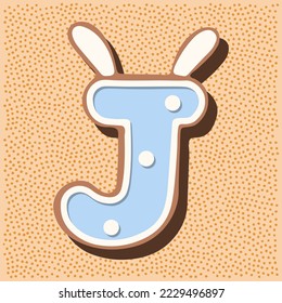 Christmas gingerbread in the shape of the letter with rabbit ears, white blue glaze, polka dots