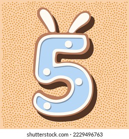 Christmas gingerbread in the shape of the namber with rabbit ears, white blue glaze, polka dots