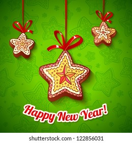 Christmas gingerbread stars with red ribbons on green background