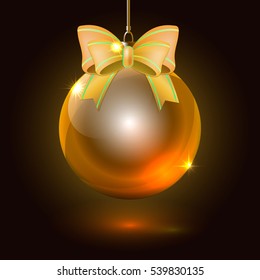 Christmas glass ball with golden bow on a dark background
