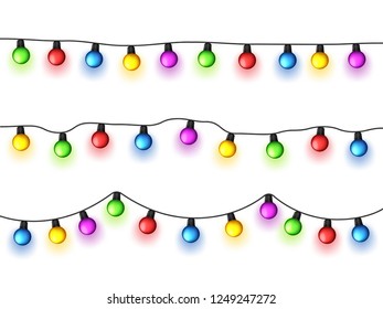 Christmas glowing lights on white background. Garlands with colored bulbs. Xmas holidays. Christmas greeting card design element. New year,winter.