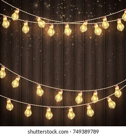 Christmas Glowing Warm Lights. Dark Brown Wooden Background. New Year Holiday Greeting Cards Concept. And also includes EPS 10 vector