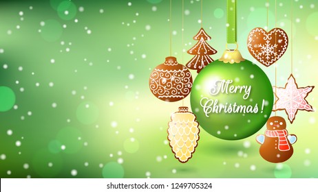 Christmas green background with a big green ball and gingerbread on strings. Inscription Merry Christmas. Wide screen