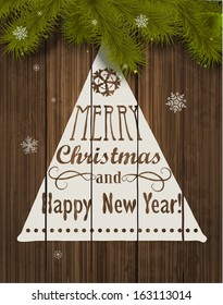 Christmas Greeting Card. Inscription with Christmas and new year 2014 against wooden texture and branches of a New Year's tree Christmas. Vector Illustration.