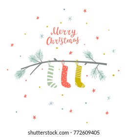 Christmas greeting card with pine branch with hanging socks and hand written lettering