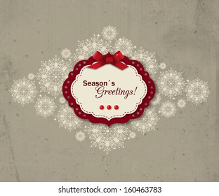 Christmas greeting  card. Season's Greetings. Vintage holiday background with ornate snowflakes  and scrapbook elements.