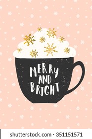 Christmas greeting card template in pink, gold, white and black. A cup of warm beverage decorated with whipped cream and gold foil snowflakes. Hand lettered text "Merry and Bright".
