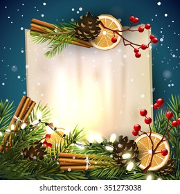 Christmas greeting card with traditional decorations  and old empty paper on blue background