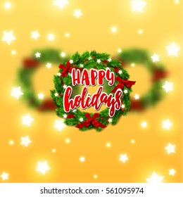 Christmas greeting card with wreath  in focus and two blurred on the background . Hand drawn calligraphy. concept handwritten happy holidays  