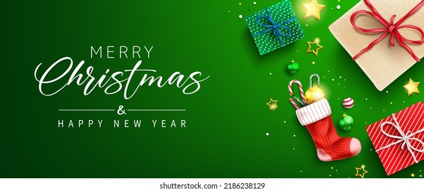 Christmas greeting vector design. Merry christmas greeting text in green space with gifts and sock stockings decoration element for xmas holiday messages. Vector illustration. 
