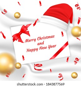 Christmas greetings card and ribbon on wool fabric with Christmas hat