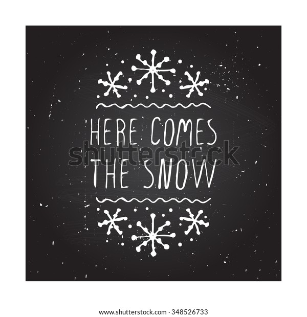 Christmas handdrawn greeting card with text on\
chalkboard background. Here comes the snow. Chalkboard typographic\
banner with text and snowflakes. Vector illustration. Handdrawn\
christmas badge.