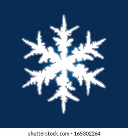 Christmas hand-drawn snowflake on deep blue background.