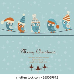 Christmas and Happy New Year greeting card with cute owls in winter caps sitting on wires. Cartoon style.