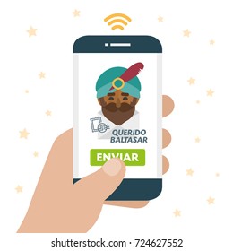 Christmas is here. Send your letter to The three wise men of orient from your cell phone. Hand holding smartphone. Dear Balthazar written in spanish